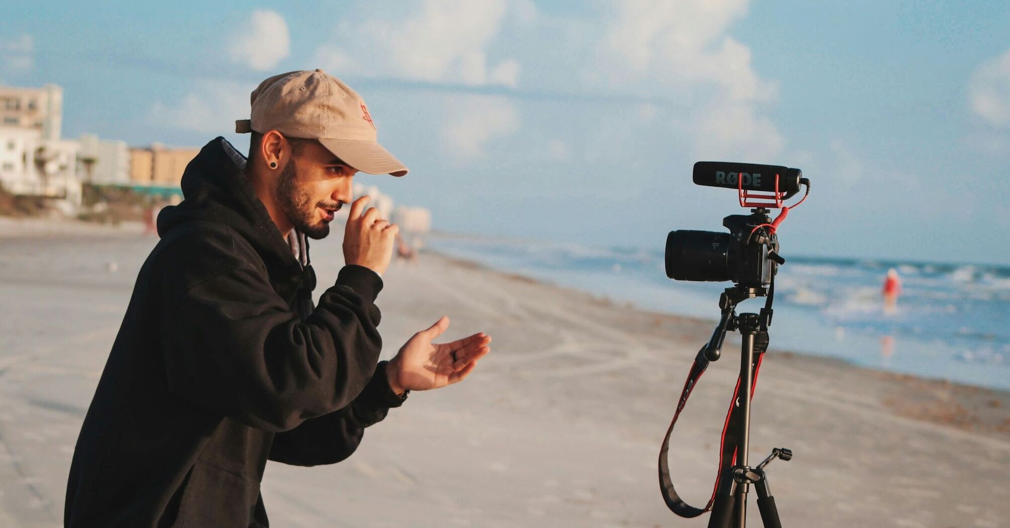 Content creator filming video on a beach