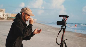 Content creator filming video on a beach