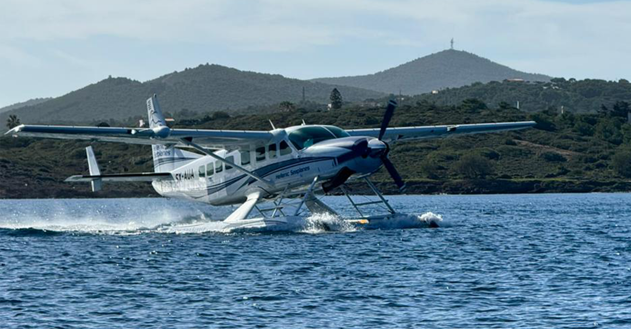 Hellenic Seaplanes aircraft taking off from the water