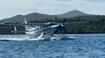 Hellenic Seaplanes aircraft taking off from the water