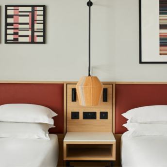 Twin hotel room with modern wall art at Manchester Marriott Piccadilly