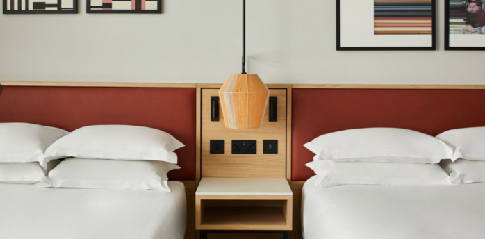 Twin hotel room with modern wall art at Manchester Marriott Piccadilly