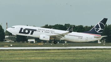 LOT Polish Airlines aircraft taking off from a runway