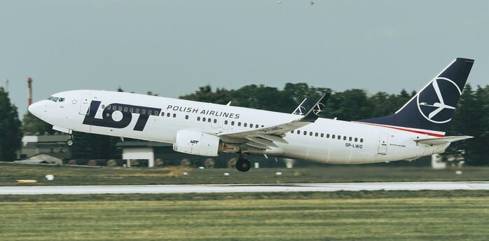 LOT Polish Airlines aircraft taking off from a runway