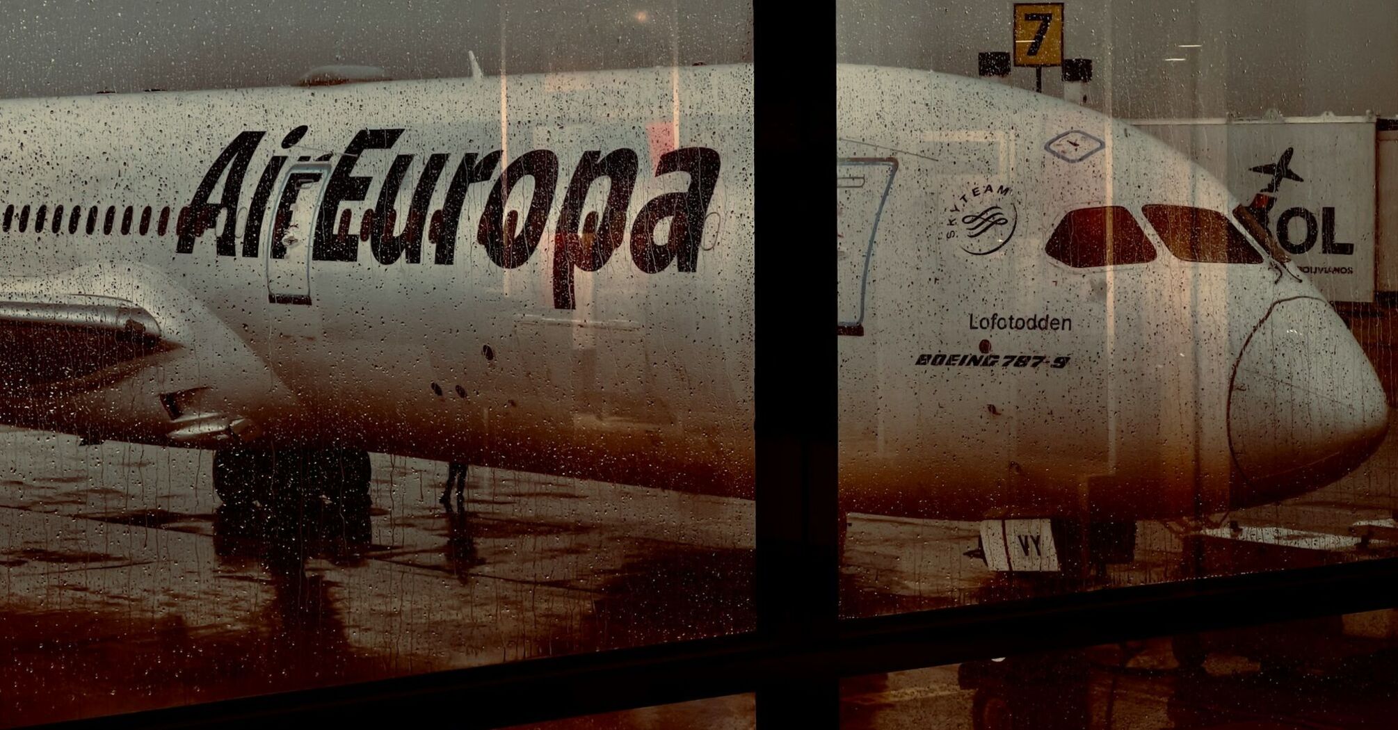 Air Europa aircraft seen through a rain-covered airport window