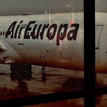 Air Europa aircraft seen through a rain-covered airport window