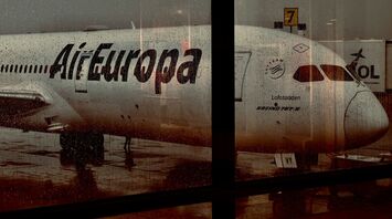 Air Europa aircraft seen through a rain-covered airport window