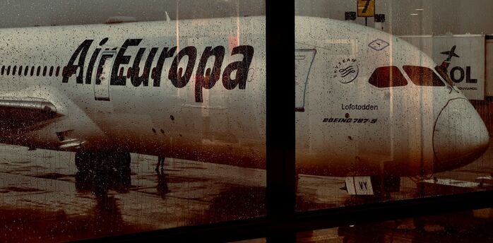 Air Europa aircraft seen through a rain-covered airport window