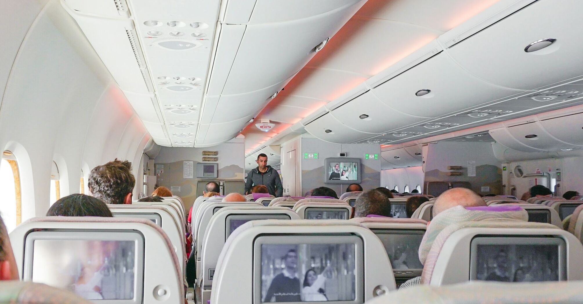 Passengers seated inside an aircraft cabin during a flight