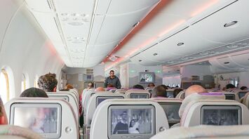 Passengers seated inside an aircraft cabin during a flight