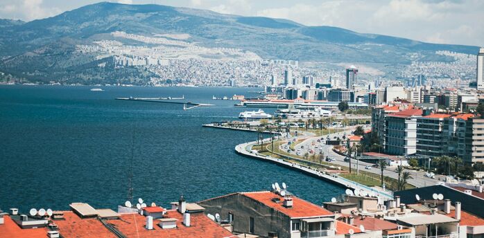 Izmir coastline with mountains and city buildings