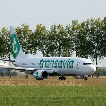 Transavia aircraft taxiing near a runway