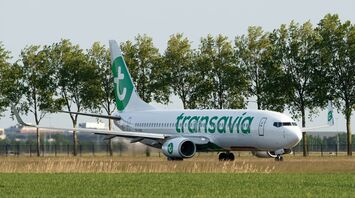 Transavia aircraft taxiing near a runway
