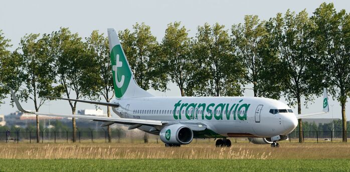 Transavia aircraft taxiing near a runway