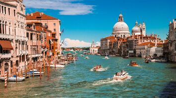 Grand Canal in Venice with boats and historic buildings on a sunny day