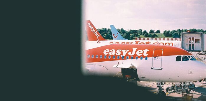 easyJet aircraft parked at an airport terminal