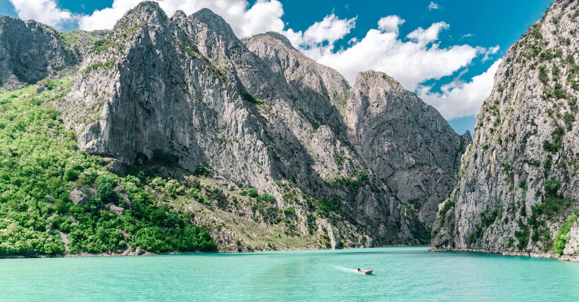 Turquoise lake surrounded by rocky mountains in Albania