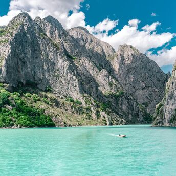 Turquoise lake surrounded by rocky mountains in Albania