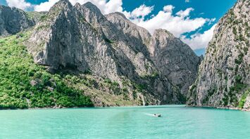 Turquoise lake surrounded by rocky mountains in Albania