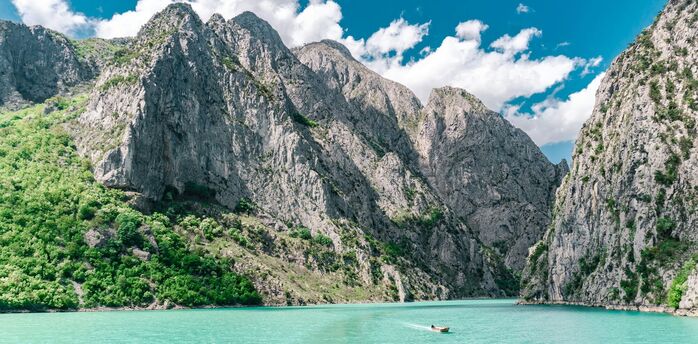 Turquoise lake surrounded by rocky mountains in Albania