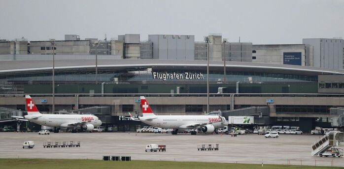 Zurich Airport terminal with SWISS aircraft