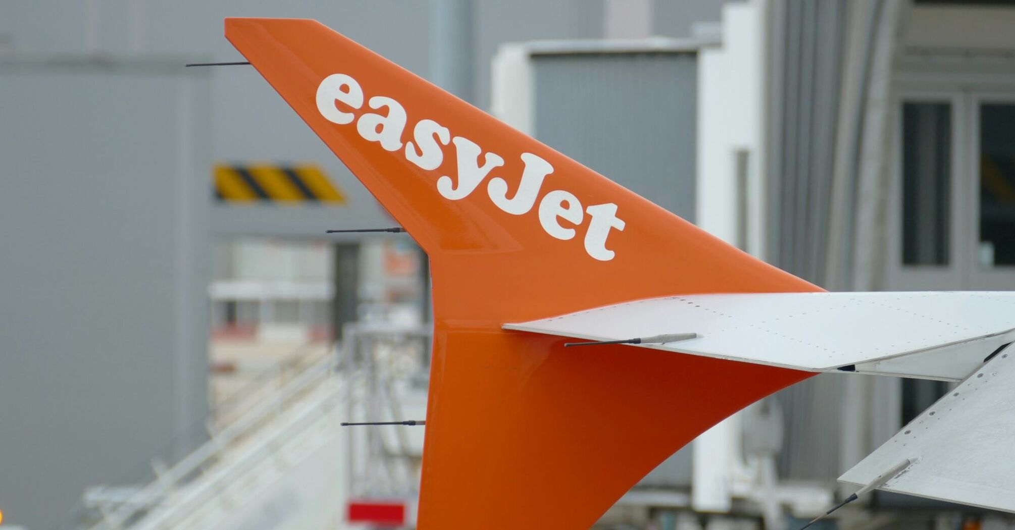 easyJet aircraft tail at an airport gate