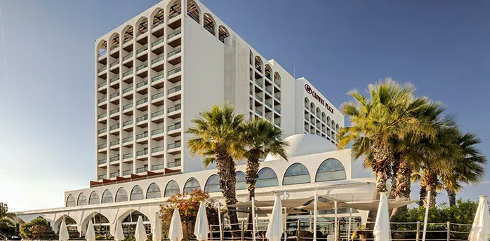Crowne Plaza hotel building in Vilamoura with palm trees outside