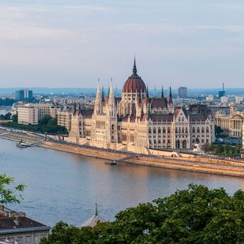 Budapest Parliament beside the Danube at sunset