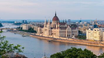 Budapest Parliament beside the Danube at sunset