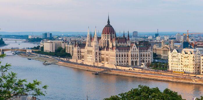 Budapest Parliament beside the Danube at sunset