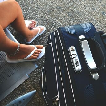 Traveller waiting beside a suitcase