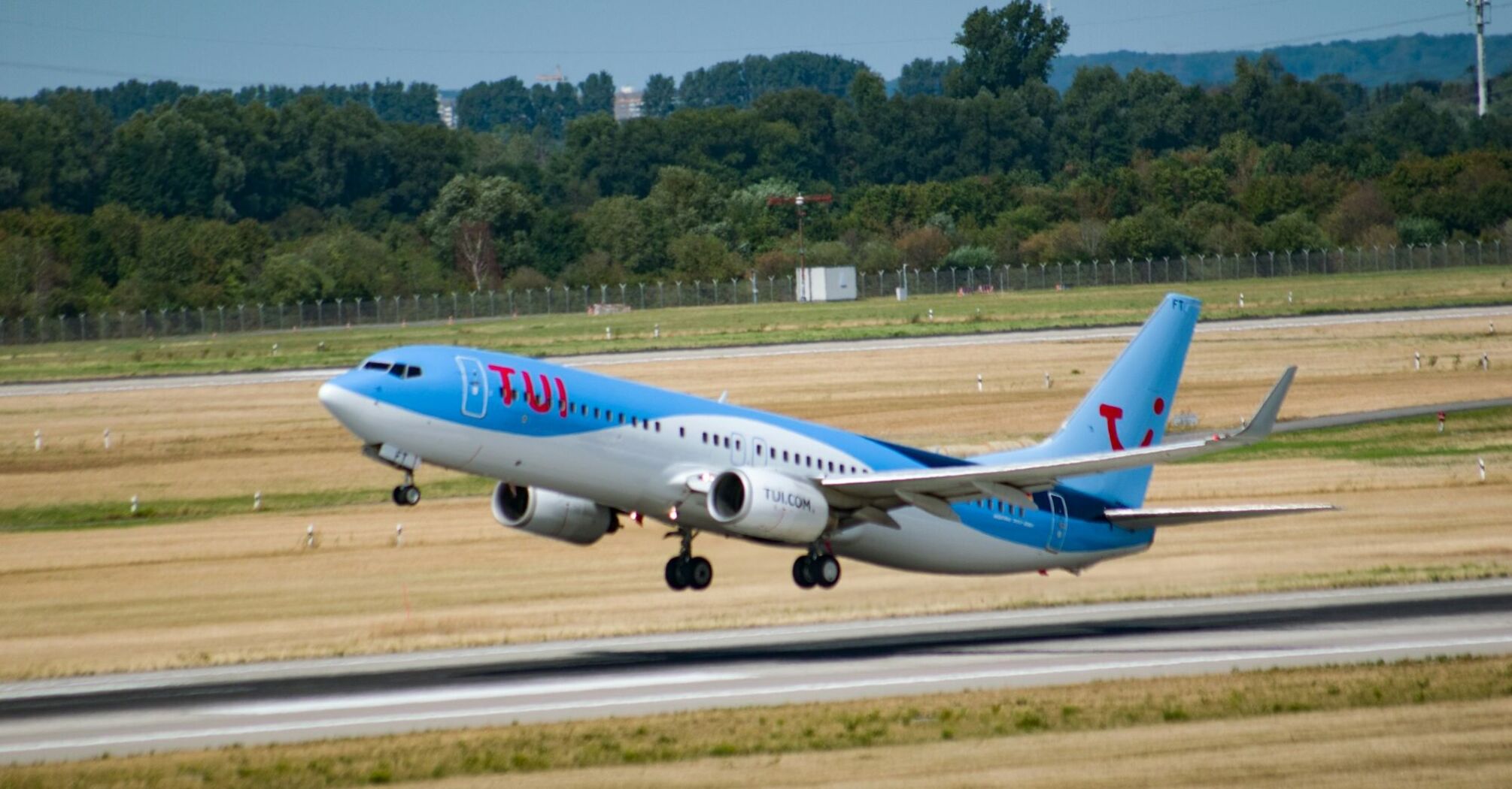 TUI aircraft taking off from an airport runway