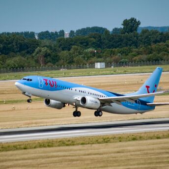 TUI aircraft taking off from an airport runway