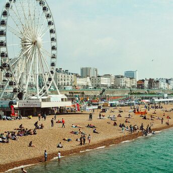 People enjoying Brighton Beach during warm summer weather