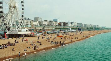 People enjoying Brighton Beach during warm summer weather