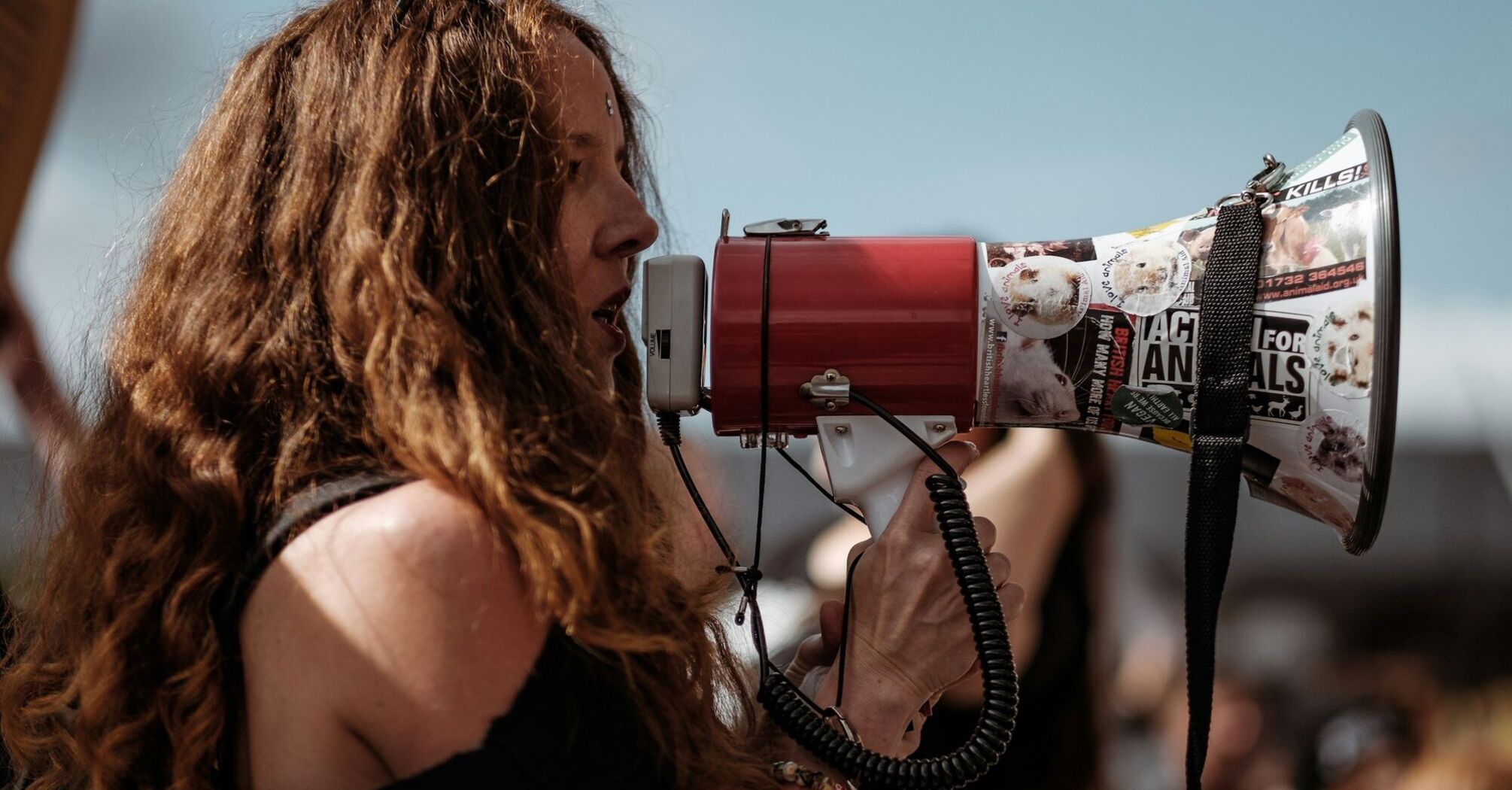 Woman speaking through a megaphone during a public protest