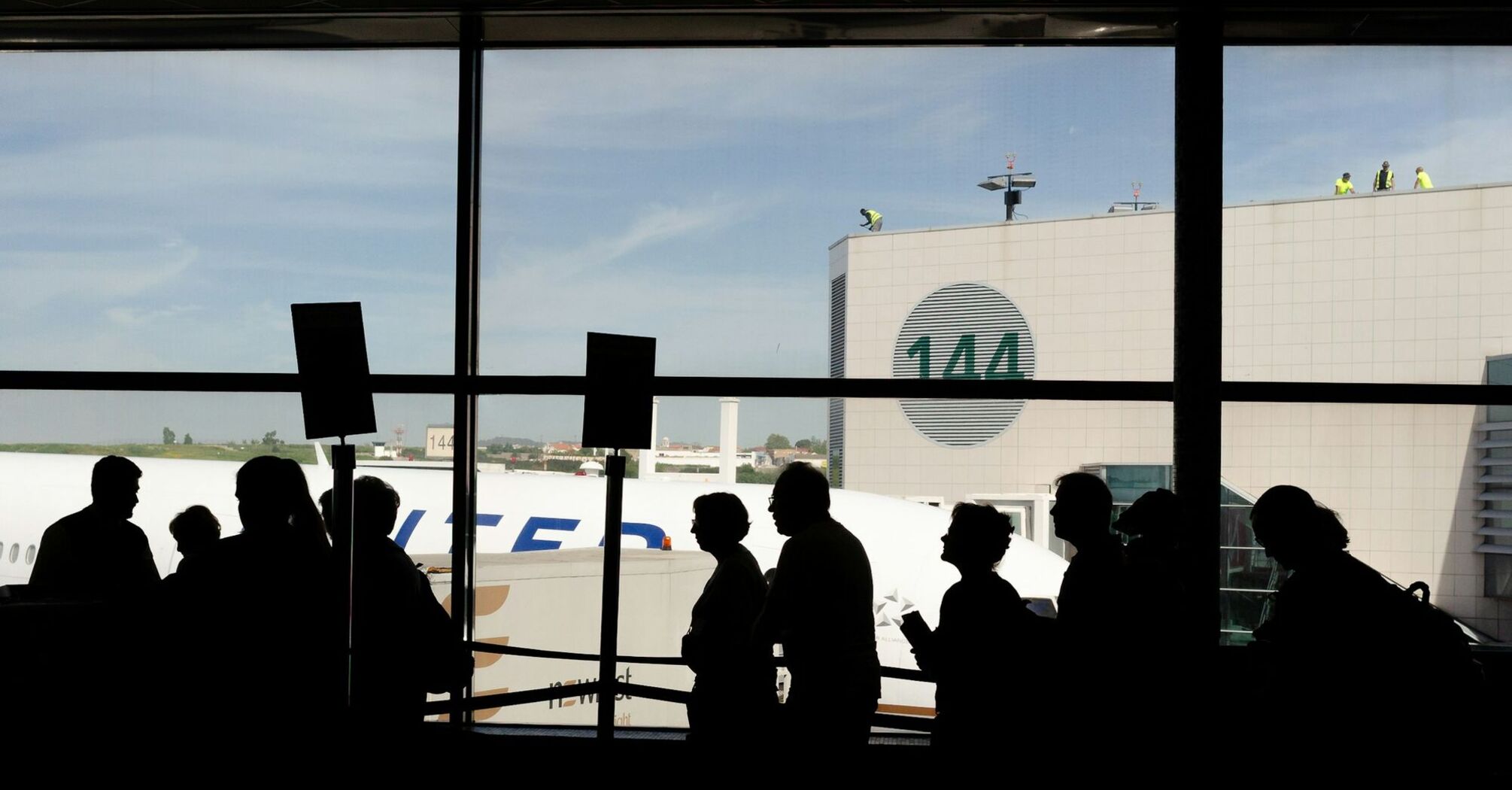Passengers queueing inside a European airport terminal