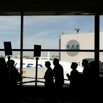 Passengers queueing inside a European airport terminal