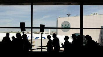 Passengers queueing inside a European airport terminal
