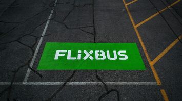 FlixBus logo painted on a marked bus stop area