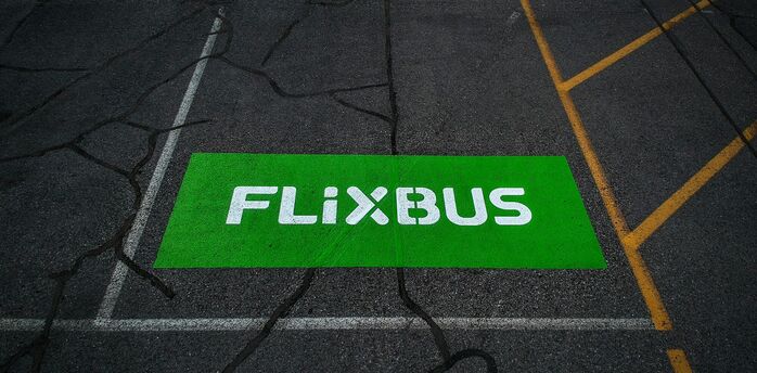 FlixBus logo painted on a marked bus stop area