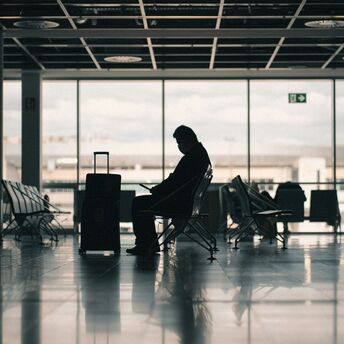 Passenger waiting with luggage in an airport terminal