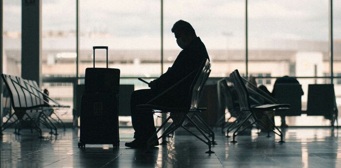 Passenger waiting with luggage in an airport terminal