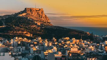 Alicante city skyline with Santa Bárbara Castle at sunset