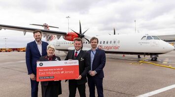 Loganair crew and airport staff mark the new East Midlands to Jersey route beside an aircraft
