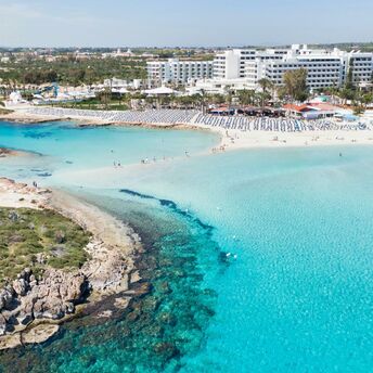 Aerial view of a sandy beach and turquoise sea in Cyprus