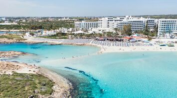Aerial view of a sandy beach and turquoise sea in Cyprus