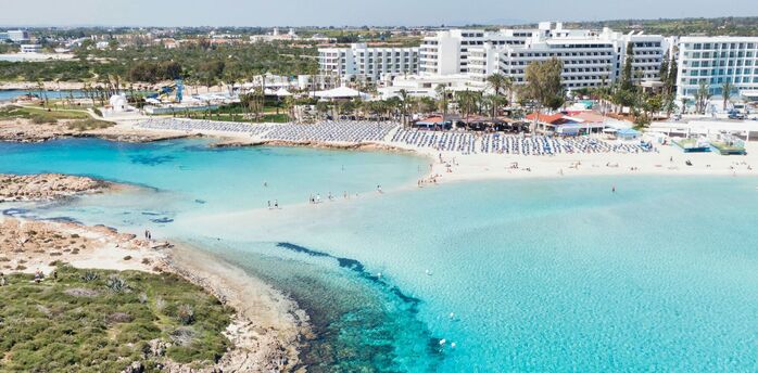 Aerial view of a sandy beach and turquoise sea in Cyprus