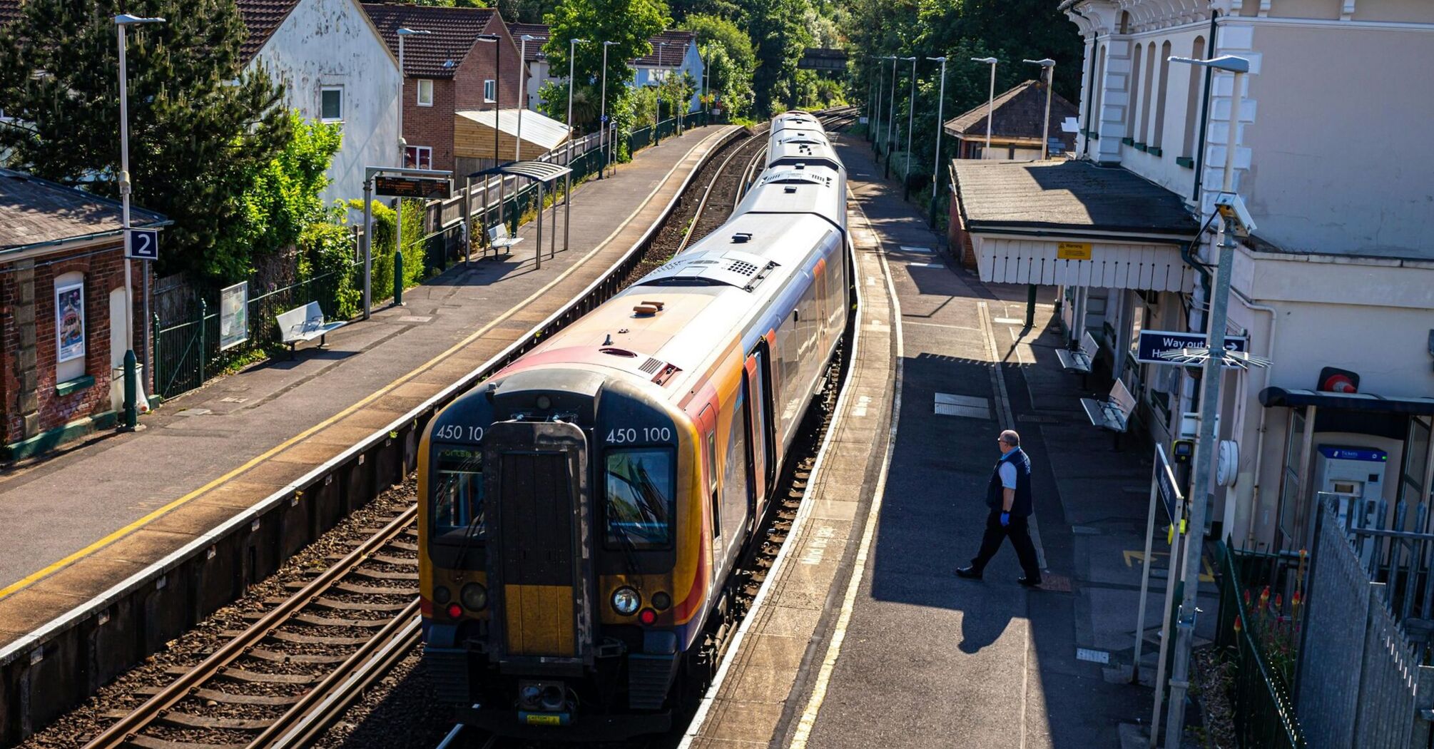 Train at a small UK station platform on a sunny day