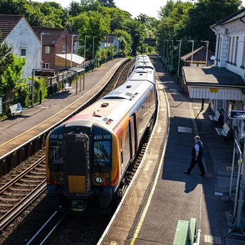 Train at a small UK station platform on a sunny day
